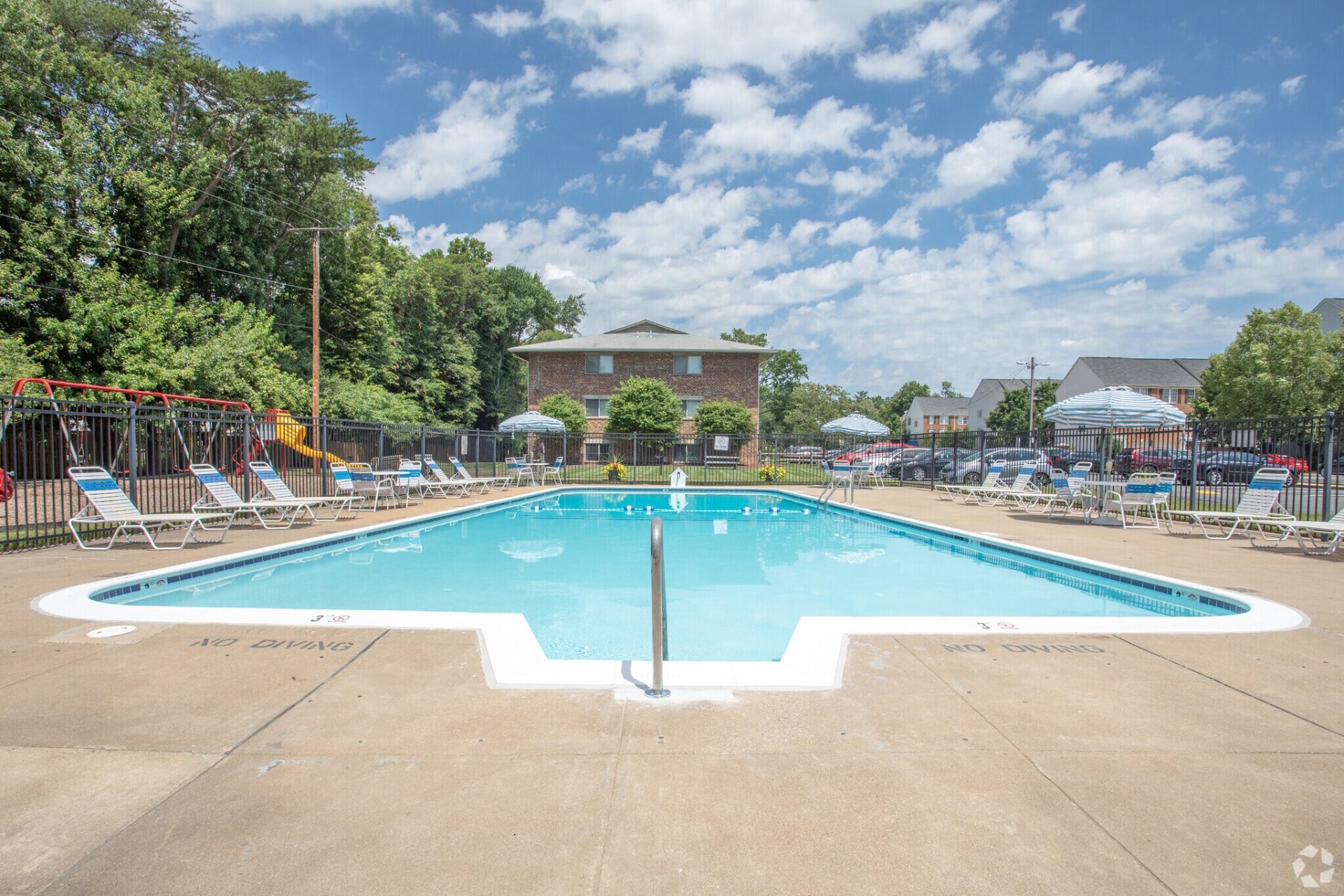 Skyview swimming pool with lounge chairs and umbrellas