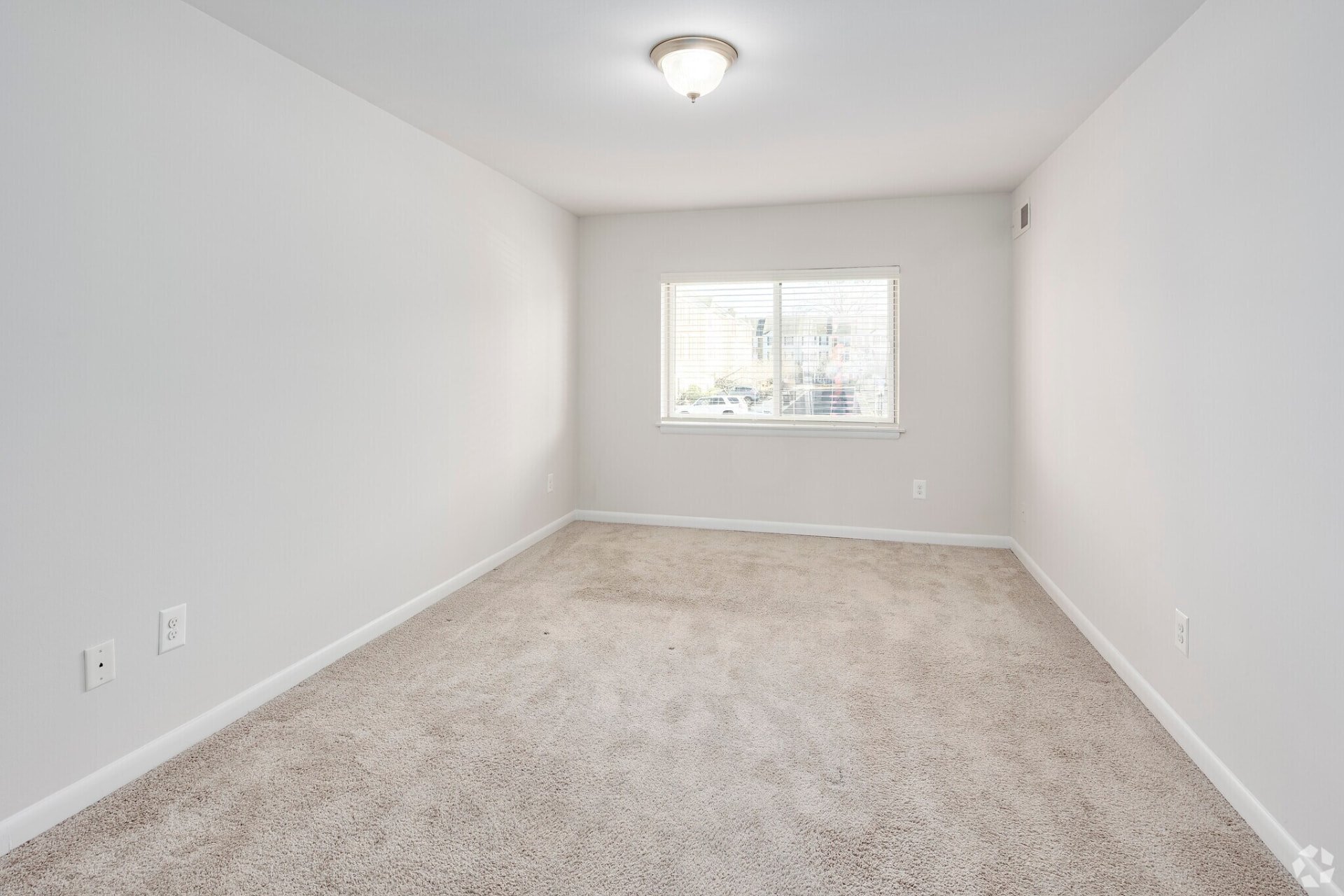 Two-bedroom apartment carpeted bedroom