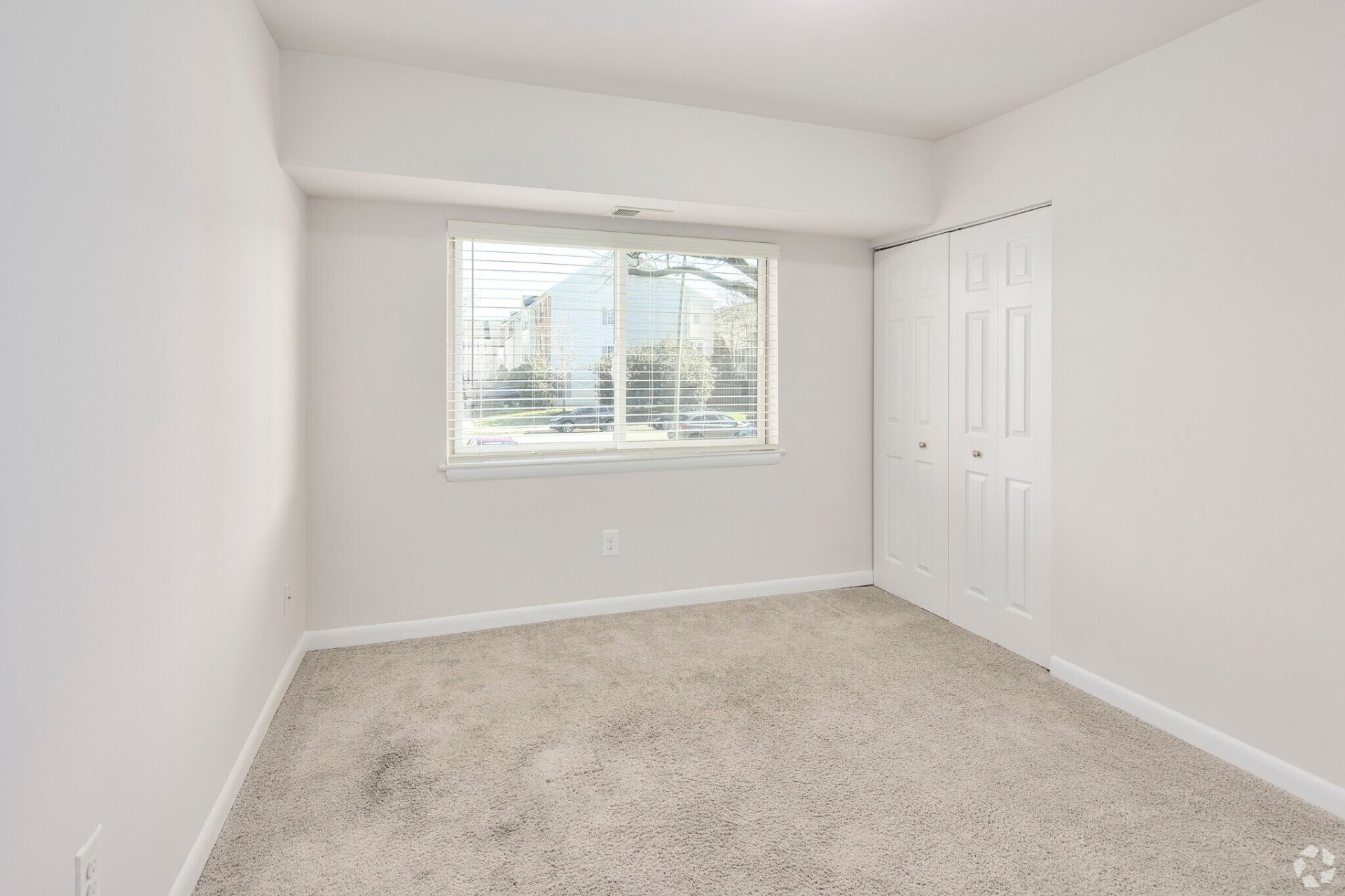 Two-bedroom apartment bedroom with a window