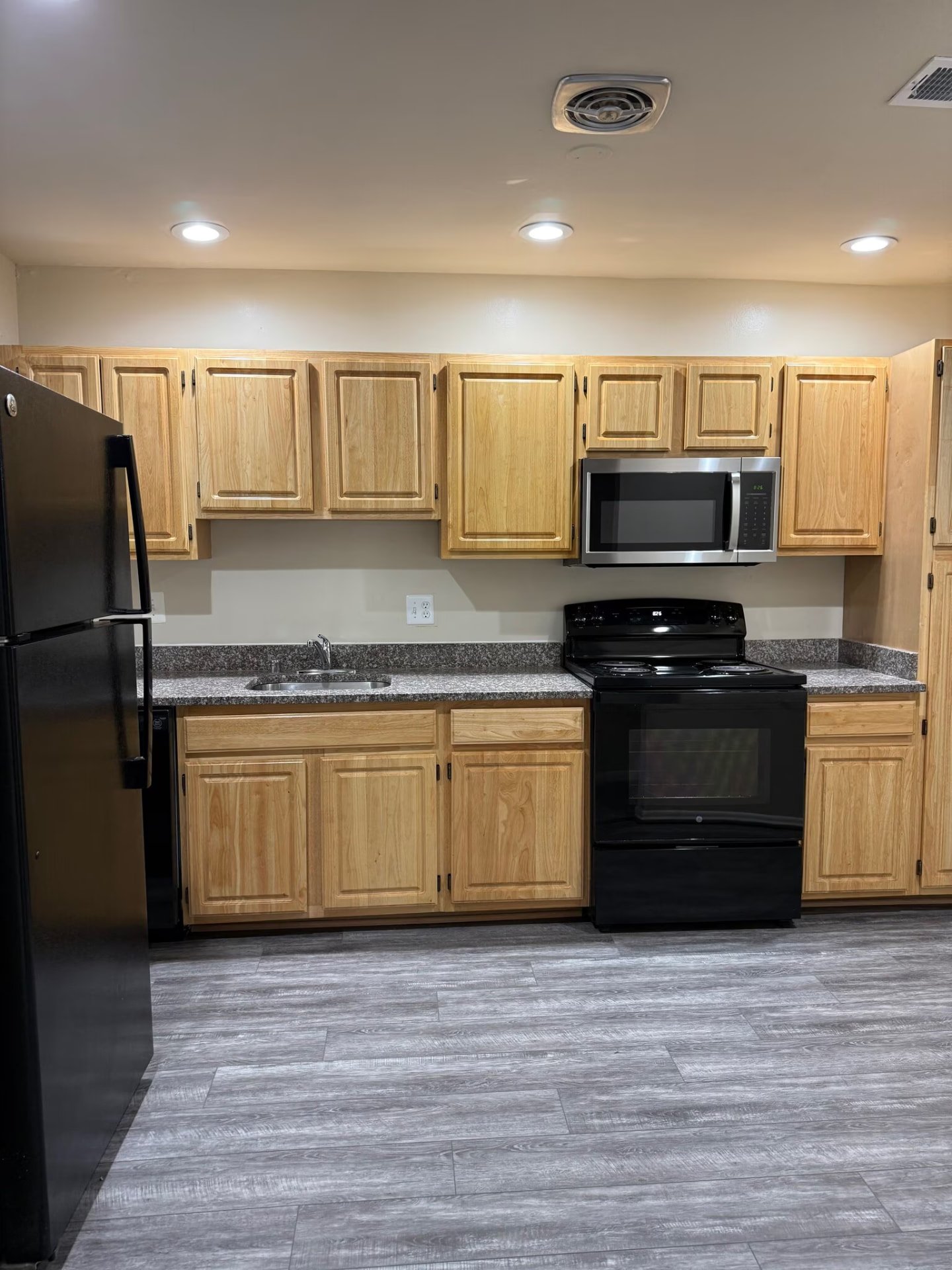 Kitchen with oak cabinets and black appliances