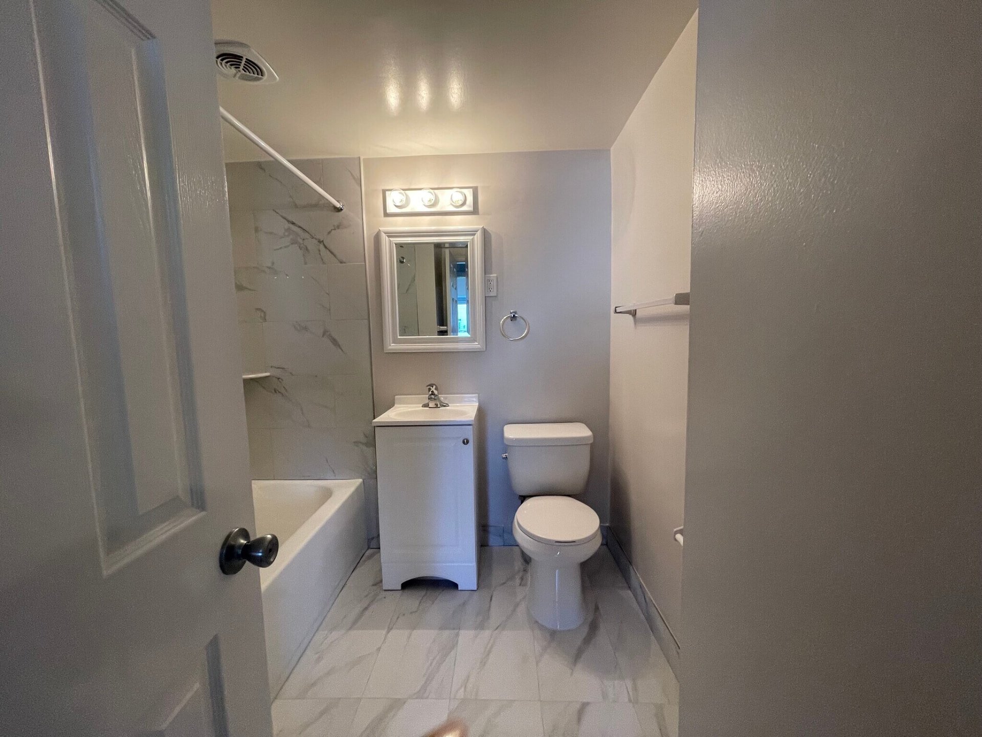 Two-bedroom bathroom with tub, vanity and toilet