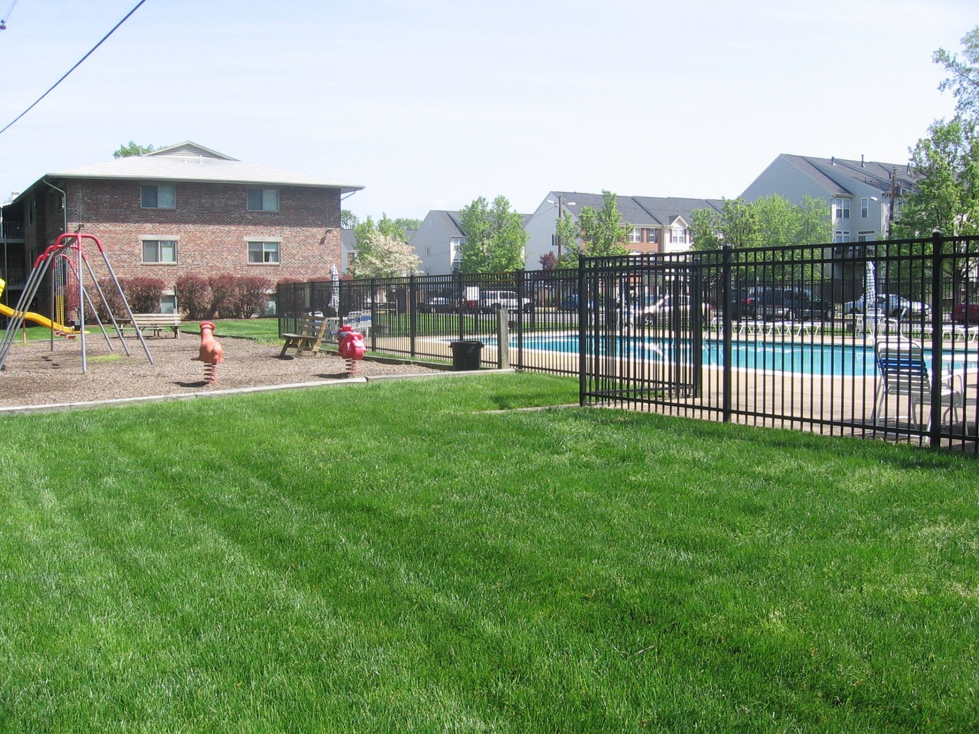 Skyview playground and fenced swimming pool area