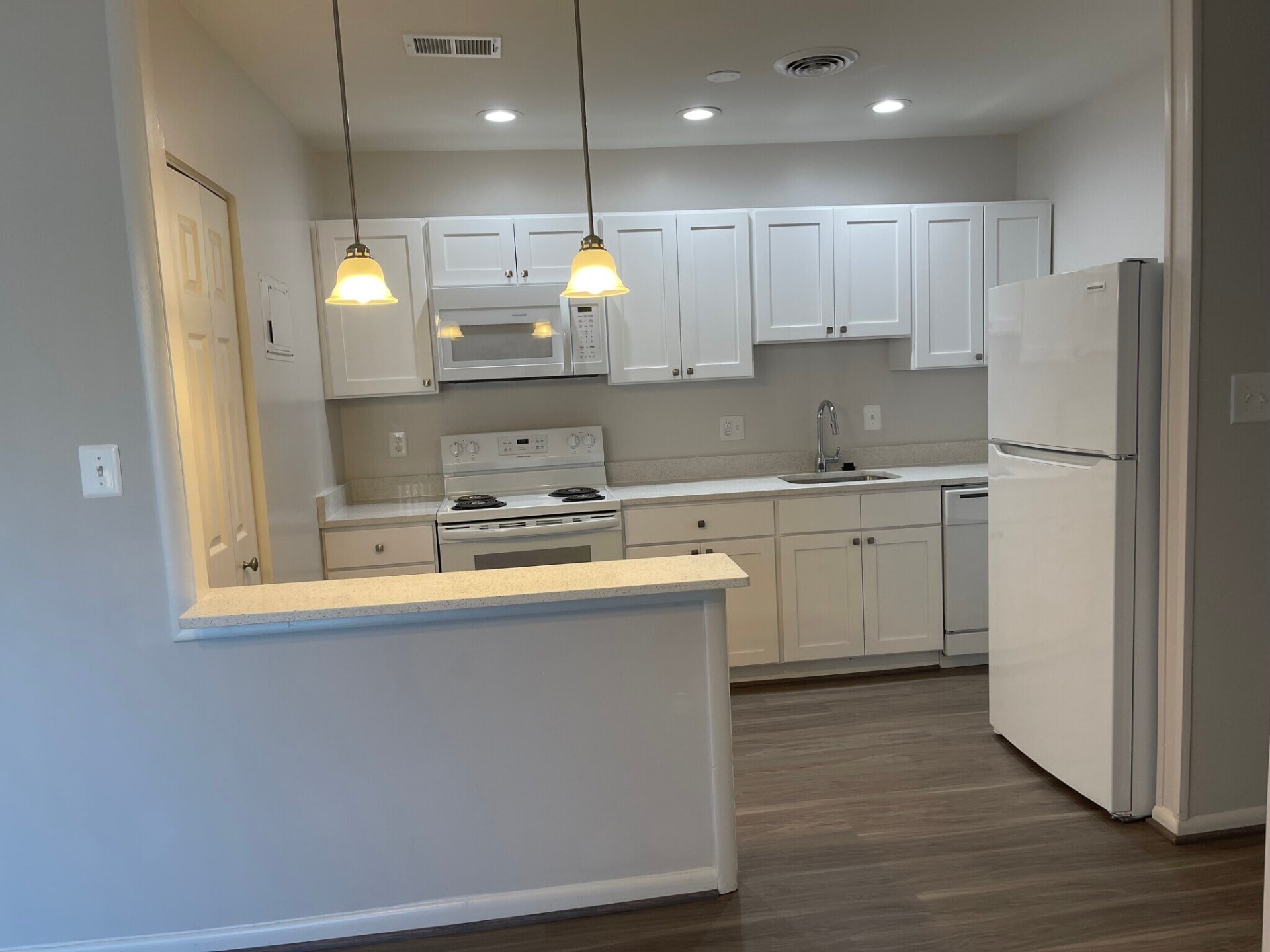 White kitchen viewed from the breakfast bar